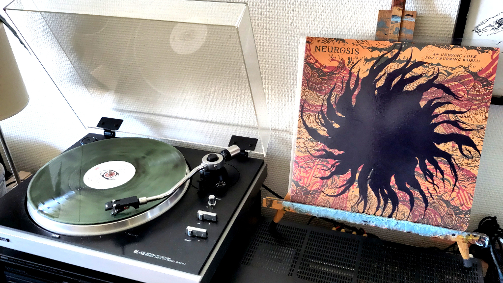 Right, the album cover stands on a table scaffold while, left, the smokey coke bottle vinyl spins on my turntable.